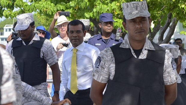 Facing 13 years in prison ... Former  Maldives president Mohamed Nasheed, centre,  after appearing at the High Court in Male, Maldives on September 9.