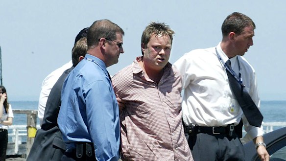 Carl Williams is arrested at Port Melbourne in 2003.