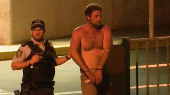 Alleged drink-driver Samuel Davidson is led away by police.