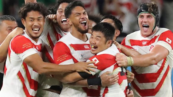 Magic moment: Japan's players celebrate after winning over Ireland.
