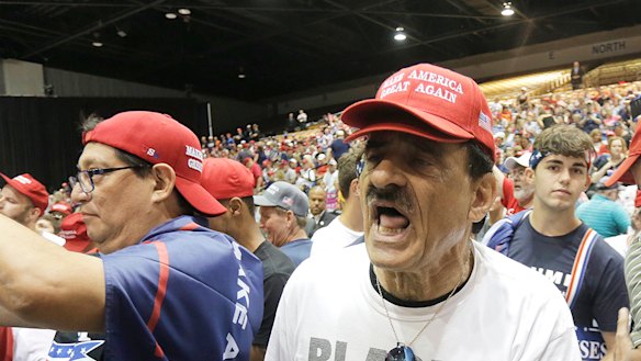 A supporter of President Donald Trump heckles CNN correspondent Jim Acosta.