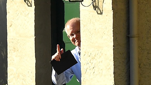Australian Prime Minister Scott Morrison gestures to media at Kirribilli House in Sydney on Sunday.,
