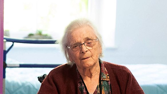 Marie Lithard, right, and her neighbour Yves Chretien sit looking out of their rooms in a nursing home in Ammerschwir, France.