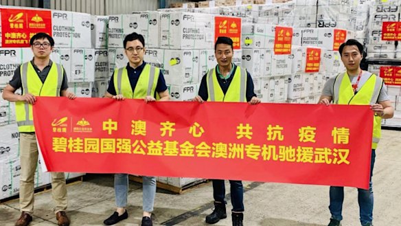 "China-Australia work as one together to fight epidemic" reads the banner being held by Risland’s CEO Dr Guotao Hu (second from left), Ray Zi, general manager, human resources & administration and former communications manager Isaac Huo.