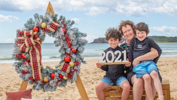 Trish Smith and her sons in a 2021 beachside Christmas photo from Facebook.