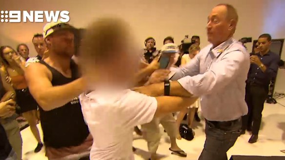 Fraser Anning strikes the young activist who egged him.