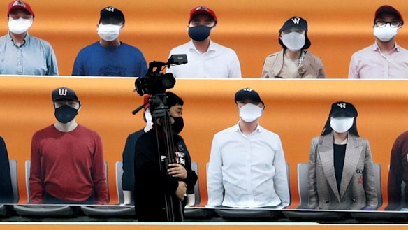 Cardboard cut-outs, like these at a baseball game in South Korea earlier this month, could fill the bleachers for the forseeable future.