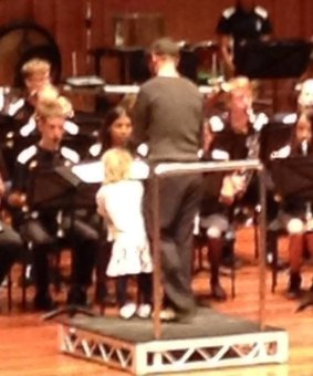 A member of the audience captured four-year-old Esther McAlary-Crispin standing patiently next to her dad, Steve.