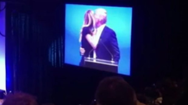 Jennifer Hawkins appears to turn her cheek as Donald Trump goes to kiss her.