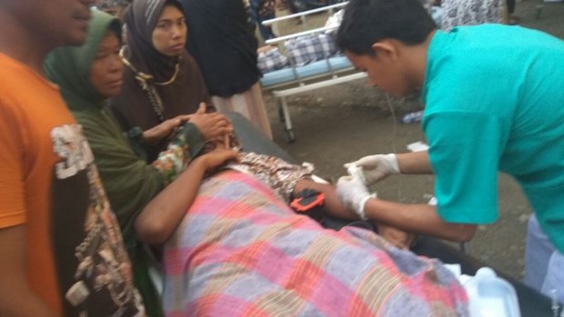 A victim is treated after Wednesday's earthquake.