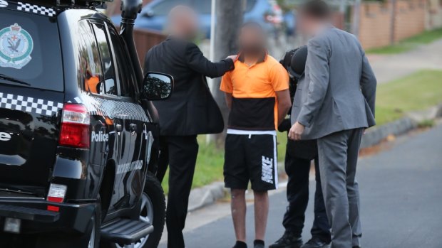 A man is arrested in a counter-terrorism operation in Merrylands last Wednesday.