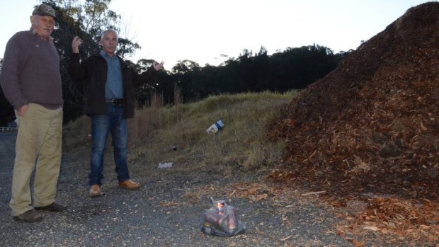 Fed up: Neighbours Rhett Mitchell and Albert Veith, who live west of Nelligen, say cleaning up rubbish travellers dump on the Kings Highway is becoming an expensive and frustrating exercise.