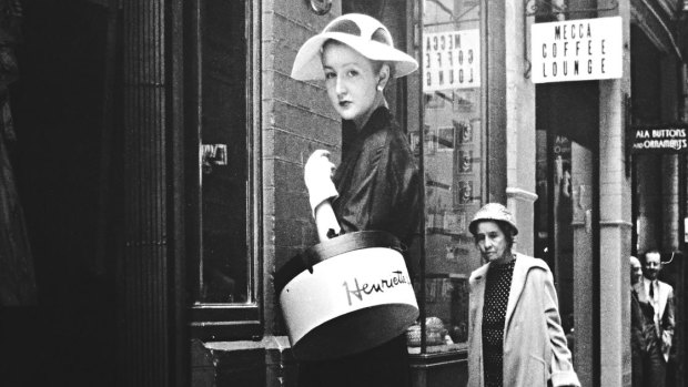 Annette Fielding-Jones, a Herald staff reporter, outside French milliner Henriette Lamotte's salon in Rowe Street, Sydney, circa 1950.