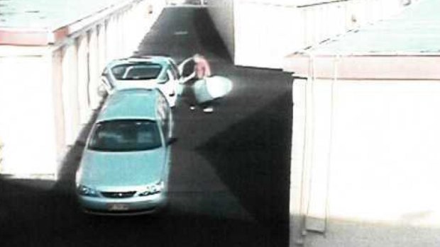 CCTV footage of the silver surfboard bag being taken out of the Ford.