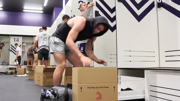 Players re-pack their lockers as they settle in to their new home.