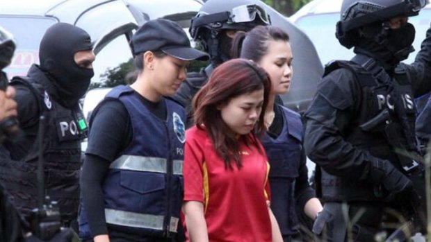 Indonesian suspect Siti Aisyah, center, is escorted by police officers as she arrives in court on Wednesday.