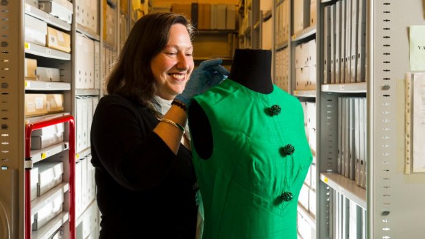 Carolyn Laffan, senior curator at the Australian Music Vault with a dress worn by Judith Durham of The Seekers at the Sidney Myer Music Bowl, 1967. 