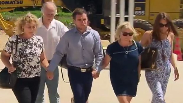 Thomas Keating (centre) arriving at Phuket police station on February 9 with members of his family, and the family of his late girlfriend Emily Collie.