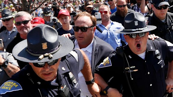 Alex Jones, second from right, an American conspiracy theorist in Cleveland, during the second day of the Republican convention. 