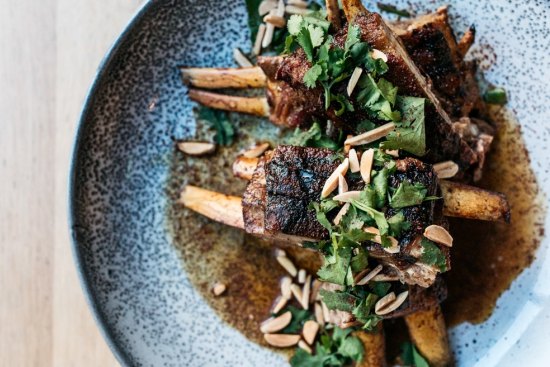 Chargrilled saltbush lamb ribs with almonds, sumac and coriander.