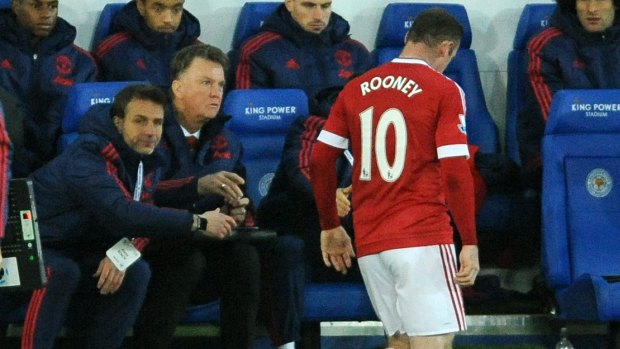 Manchester United's Wayne Rooney walks past manager Louis van Gaal after being substituted.
