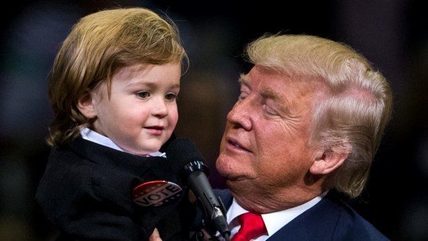 Donald Trump holds two-year-old Hunter Tirpak, who is dressed as Trump, during a rally in Pennsylvania last week.