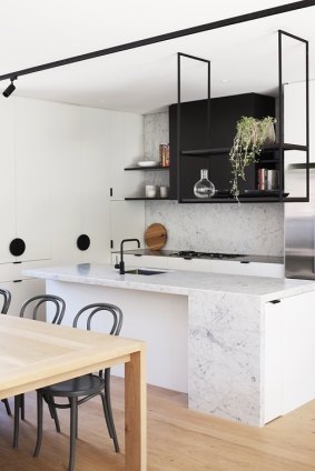 The open-plan kitchens boast Cararra marble bench tops.