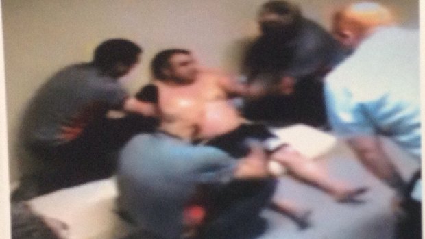 CCTV from December 2015 shows security guards restraining a detainee at the Maribyrnong centre.