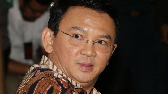 Jakarta governor Ahok, sits on the defendant's chair at the start of his trial.