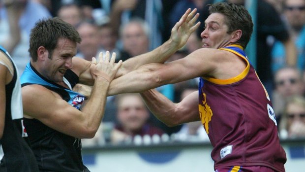 Alastair Lynch (right) tangles with Port Adelaide's Darryl Wakelin during the 2004 grand final.