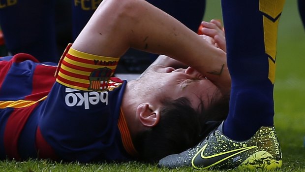 Out:  Lionel Messi lies on the pitch injured during a Spanish La Liga soccer match against Las Palmas.