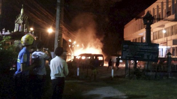 A vehicle burns outside Thalang police station in Phuket, Thailand.