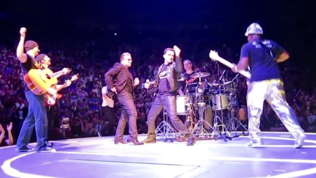 Bono with U2 tribute band 'Acrobat' on stage in Toronto. The cover band was invited on stage to play 'Desire' during an official U2 gig.