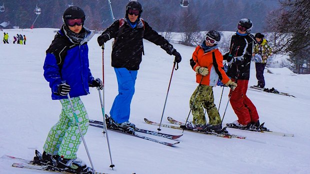 Robert Lake and his sons skiing in Austria in 2012. He always gets travel insurance for foreign ski trips but wouldn't consider it in Australia.