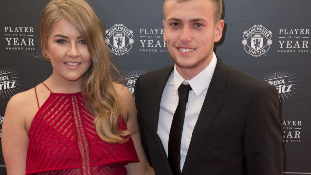 Manchester United's striker James Wilson on the red carpet with his partner.
