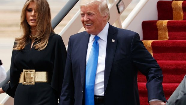 Melania Trump wearing a gold Yves Saint Laurent belt.