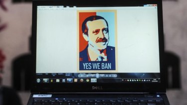 A computer screen shows a portrait of Turkish Prime Minister Recep Tayyip Erdogan.