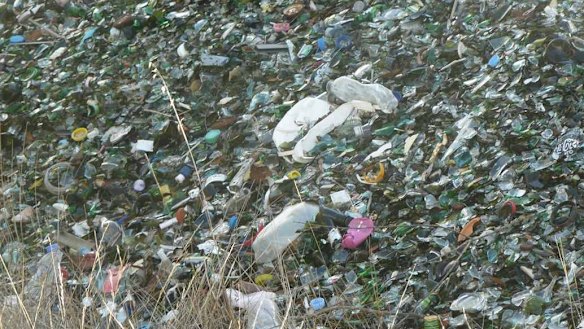 Plastic and other rubbish is mixed up in the unwashed recycled glass.