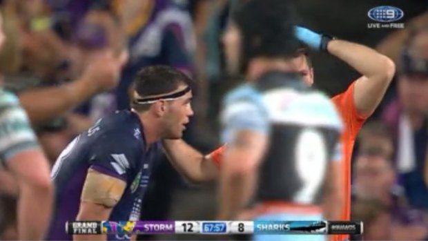 Not removed from field: Dale Finucane is attended to by a Storm trainer during the 2016 grand final against Cronulla Sharks but was allowed to play on.