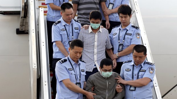 Six fugitives accused of economic crimes are taken back to China under escort from Indonesia in June 2015 as part of Operations Fox Hunt and Skynet.