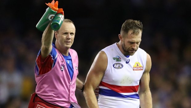 Travis Cloke moves slowly from the field after the collision. It was a painful way to finish his 250th game.