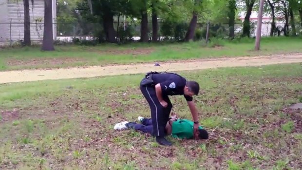 North Charleston police officer Michael Slager checks the pulse of 50-year-old Walter Scott after allegedly shooting him in the back.