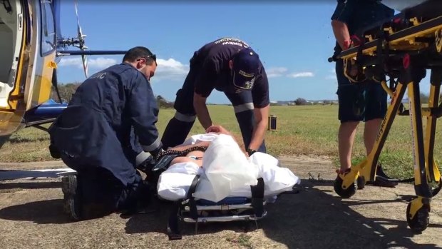 A man believed to be in his 40s was taken to Bundaberg Base Hospital  after a pod of whales capsized his tinnie.