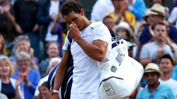 Hasta la vista: Rafael Nadal looks dejected  after his five-set loss to Gilles Muller.  