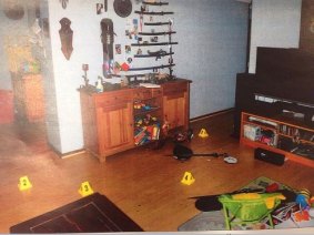 One of the many crime scene photos taken from inside the home. This shows swords on the wall and kids toys on the floor.