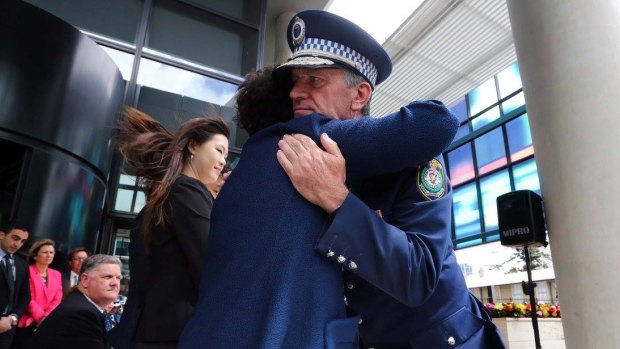 NSW Police Commissioner Andrew Scipione comforts Selina Cheng at Friday's ceremony.