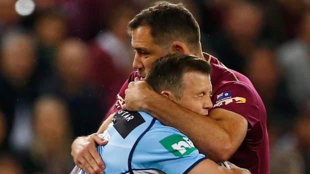 Lung-busting: Brett Morris is tackled during the frenetic opener to the State of Origin series.