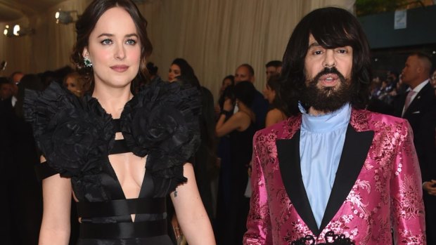 Gucci creative director Alessandro Michele, pictured with Dakota Johnson, said the label's Dapper Dan reference was an "exploration of faux-real culture". 