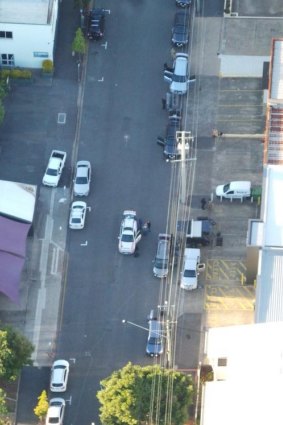 Police arrest a man following an eight-hour stand off in Bowen Hills.