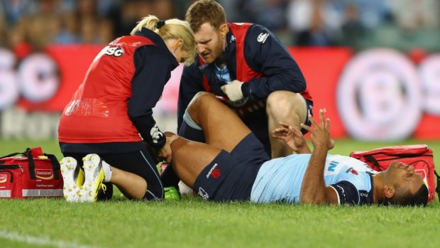Ouch: Kurtley Beale receives treatment in the first minute.